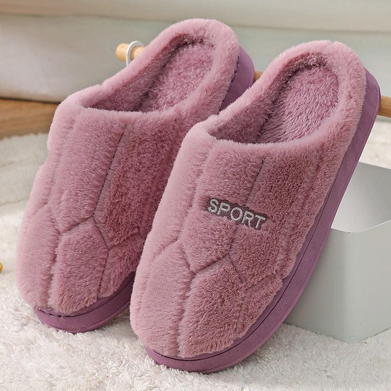 Unisex plush indoor house slippers in neutral grey and dusty rose pink with geometric pattern