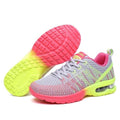 Women’s athletic running shoes in grey, neon-pink, and neon-yellow with knit mesh finish