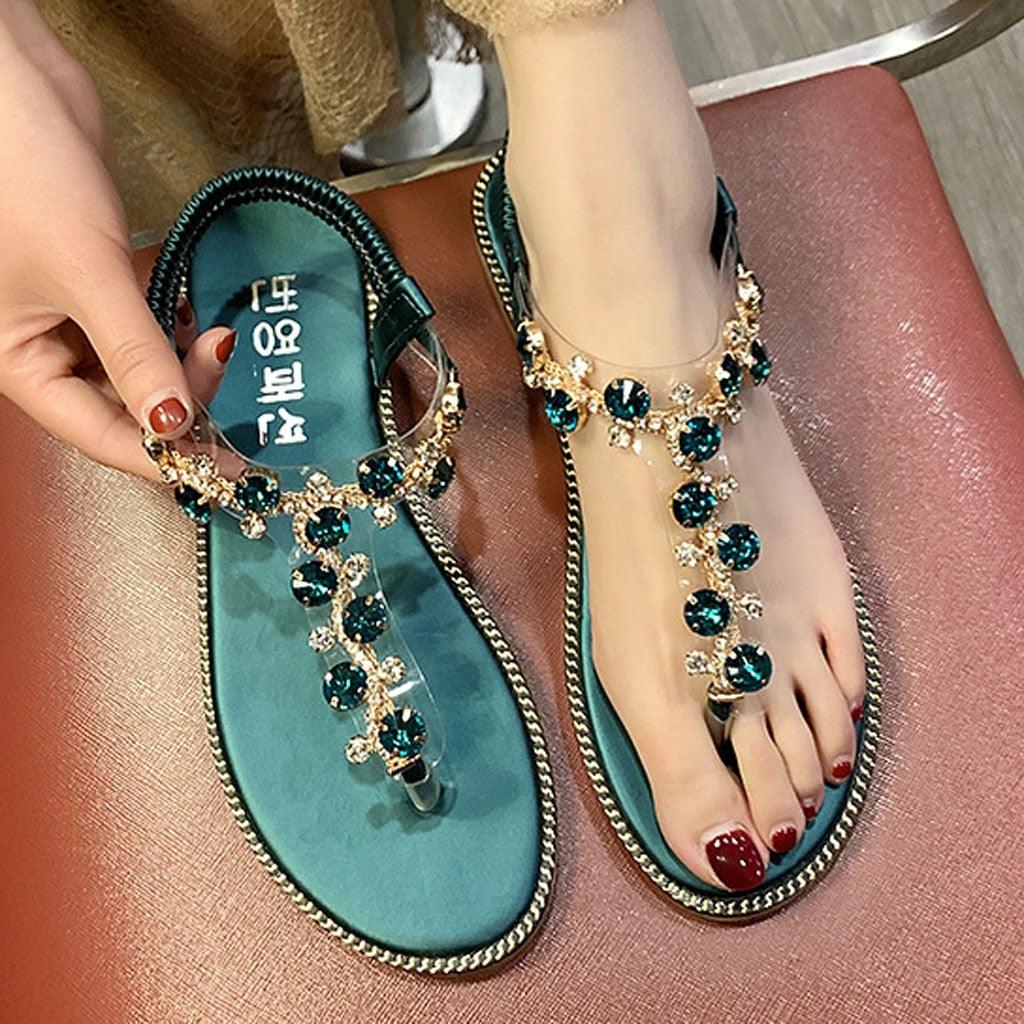 A pair of glamorous women's rhinestone platform flat sandals in black and gold.
