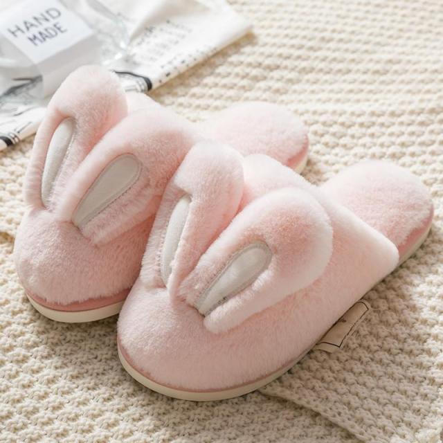 A pair of cute, plush rabbit ear house slippers with a soft memory foam sole on a neutral background.