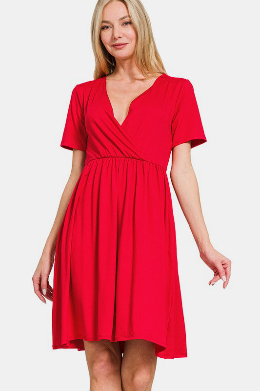 A woman wearing a solid red surplice short sleeve brushed DTY dress with a minimalist aesthetic.