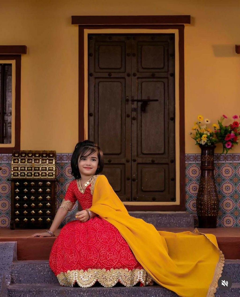 Little girl wearing a red faux georgette lehenga choli set with digital print and sequins embroidery