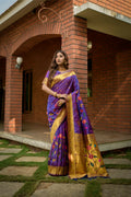 Purple Paithani silk saree with gold zari woven accents and a matching blouse.