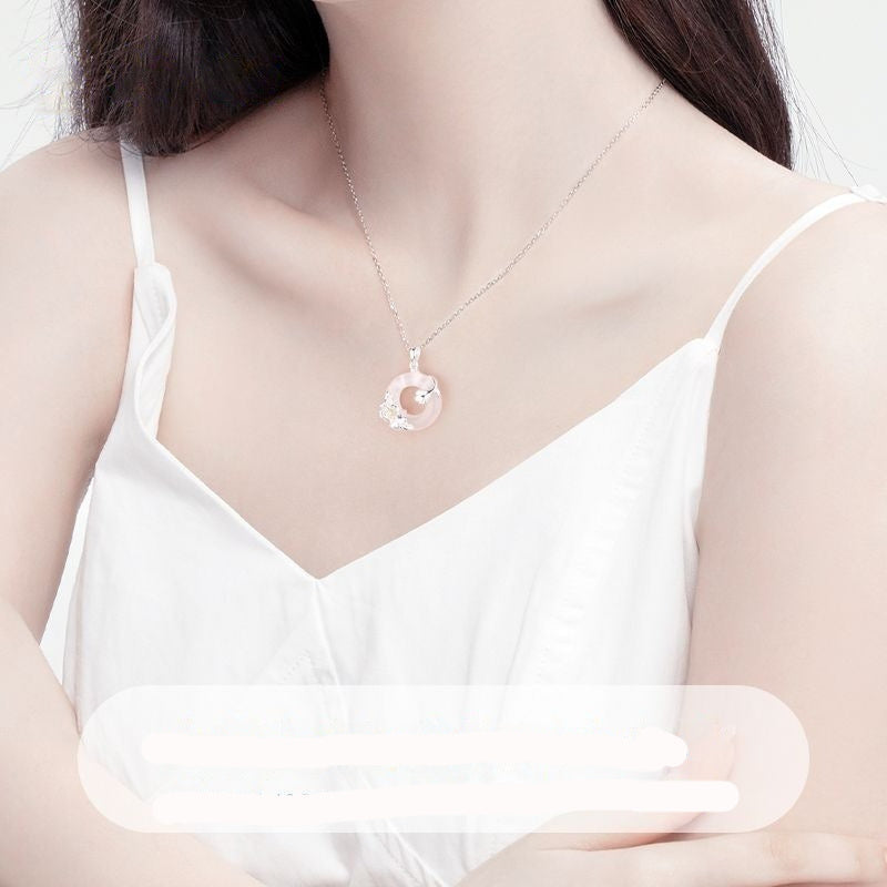 S925 Sterling Silver Camellia flower and Peace-Button pendant necklace on a delicate cross chain.
