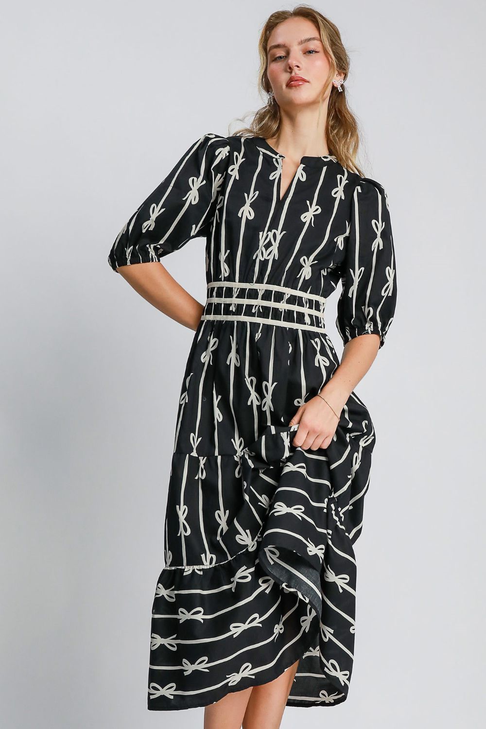 Black and cream midi dress with bow tie print and velvet trim details