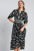 Black and cream midi dress with bow tie print and velvet trim details