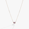 February birthstone necklace featuring a gold-plated barrel pendant with an amethyst-hued crystal on a fine cable chain.