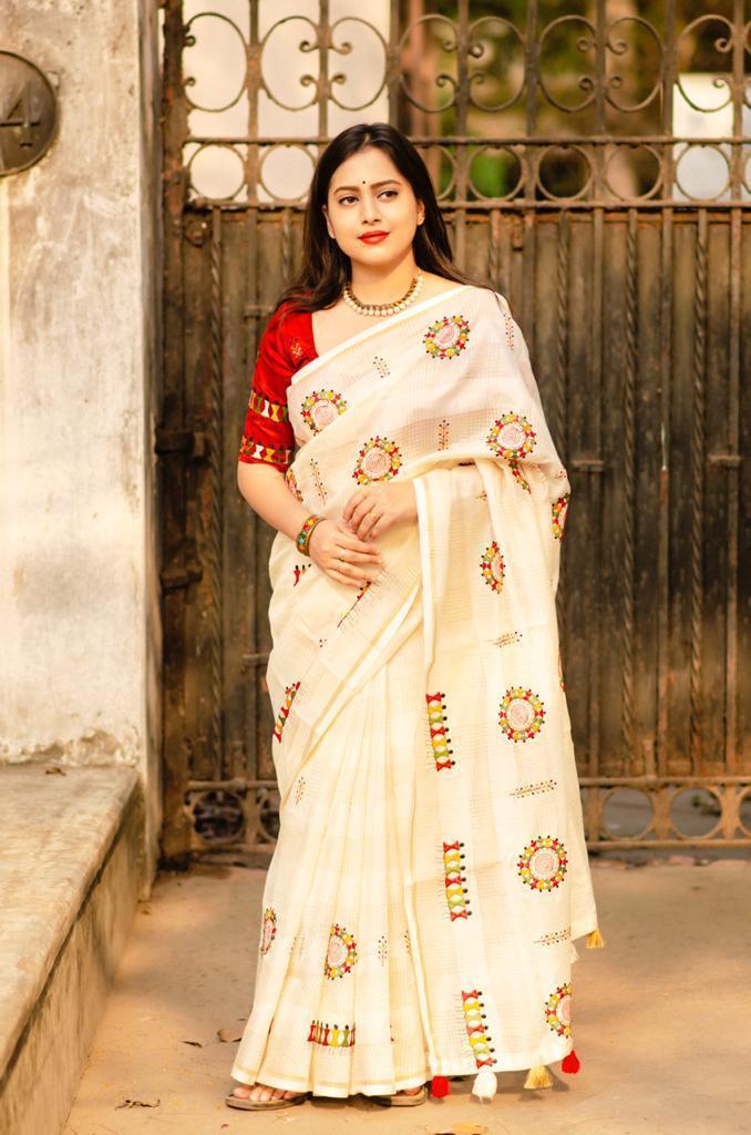 Cream cotton blend saree with all-over Warli embroidery and zari border