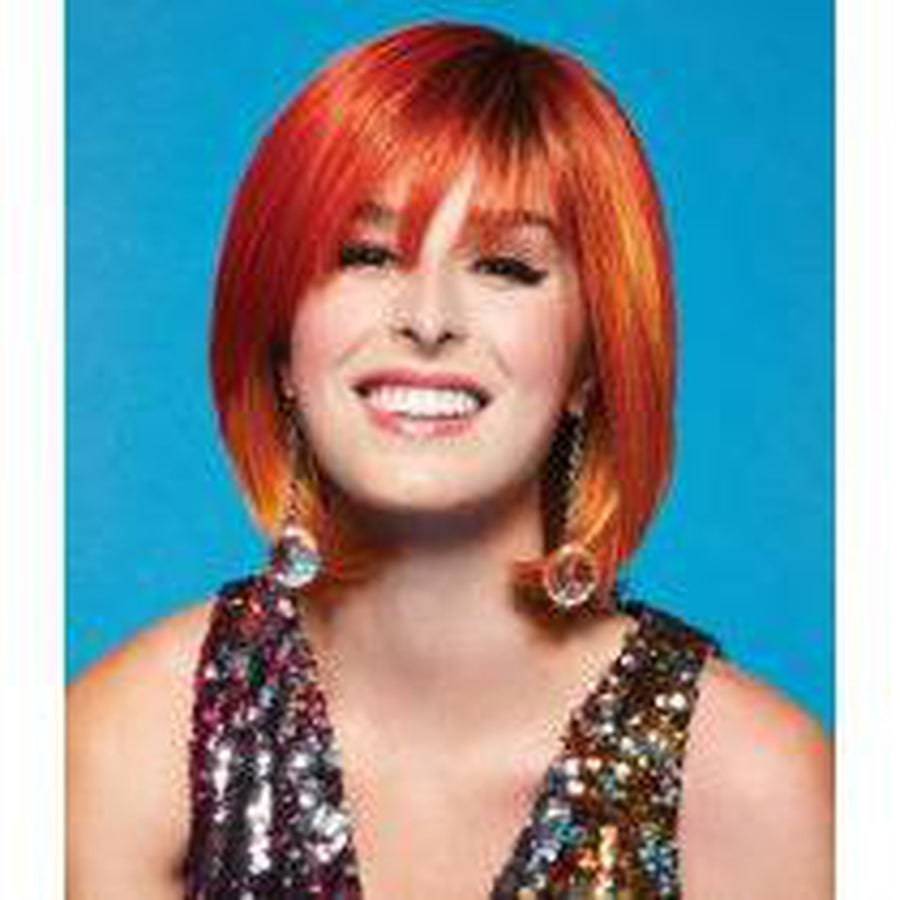 Woman wearing a vibrant orange and red Fierce Fire Fantasy wig with a glamorous, bold style.