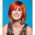 Woman wearing a vibrant orange and red Fierce Fire Fantasy wig with a glamorous, bold style.