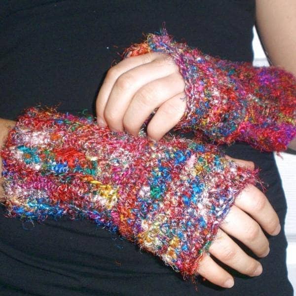 Close up of handmade crochet fingerless mittens in a neutral color palette