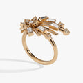 Gold-tone starburst statement ring featuring clear crystal accents on a white background
