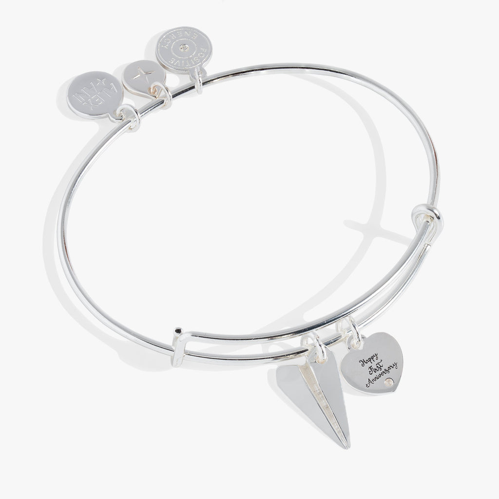 First anniversary bangle featuring a paper airplane charm and a crystal-adorned Happy First Anniversary tag