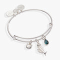 Expandable wire bangle with cat face, fish bone, and blue sapphire-colored crystal charms.
