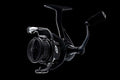 Fission Spinning Reel in black with a textured grip handle