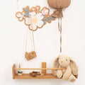Decorative flower-shaped wall hooks for nursery organization and room decor
