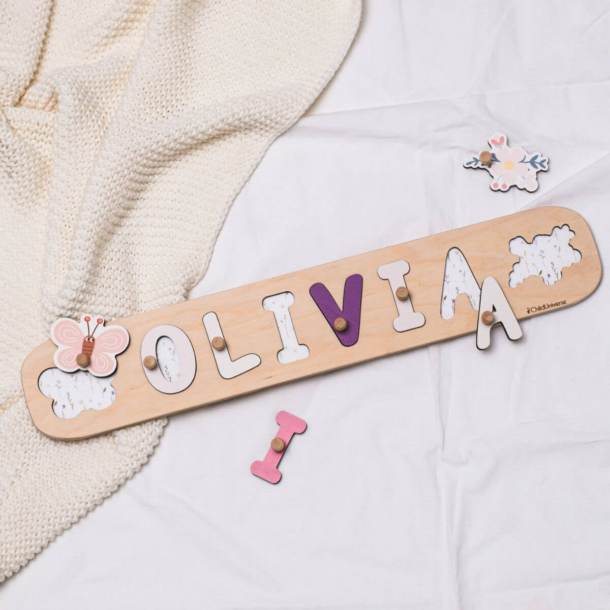 Personalized wooden name puzzle with butterfly design on a natural wood surface