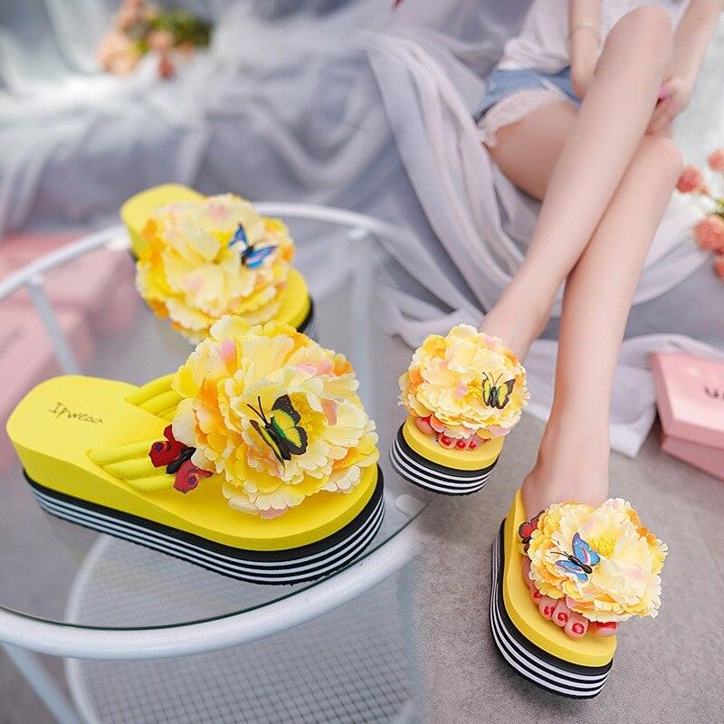 Women's floral print platform slide sandals in a bright, playful bohemian style for beach and pool wear.