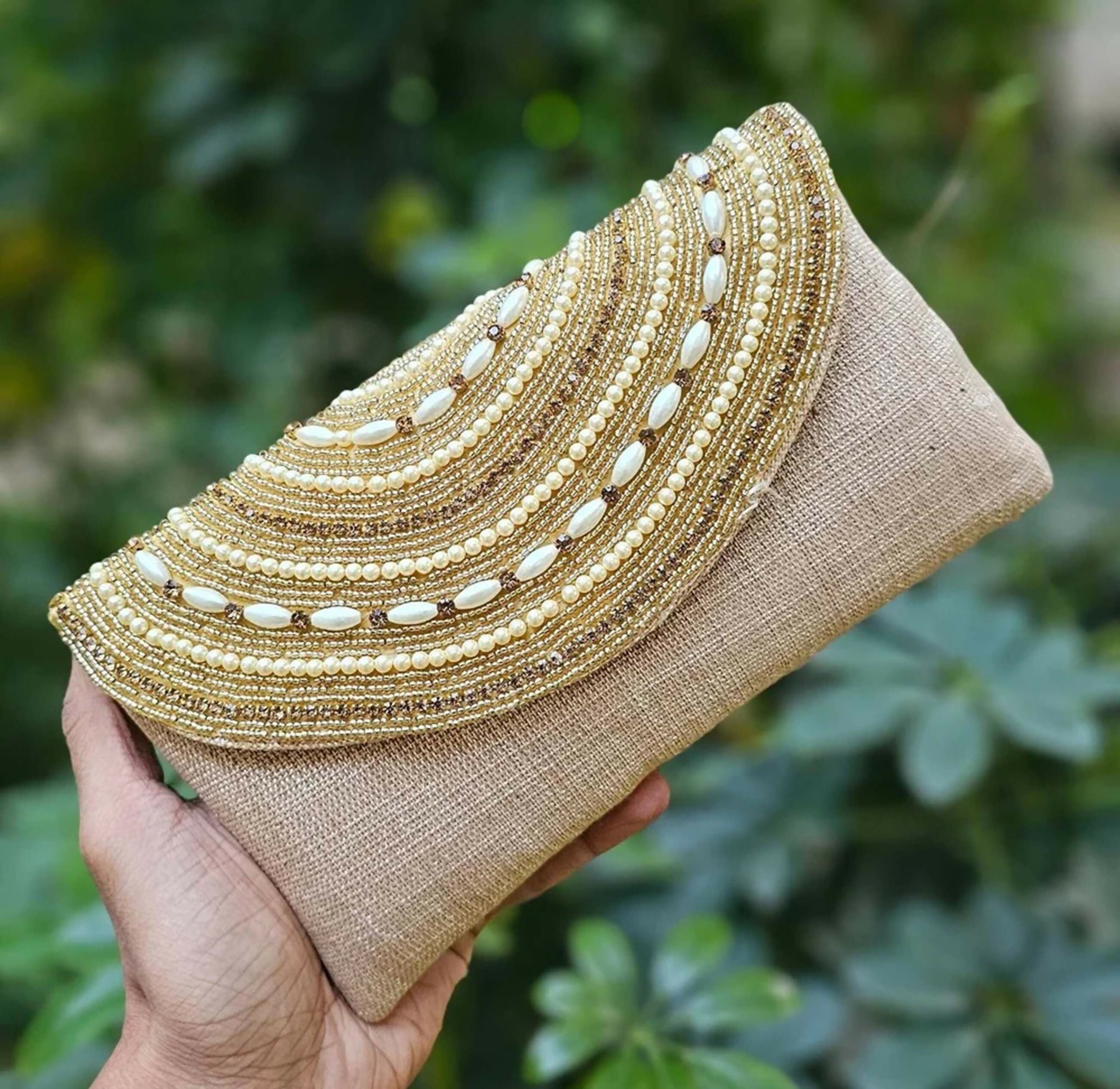 Golden embellished potli clutch for women featuring intricate detailing and synthetic fabric