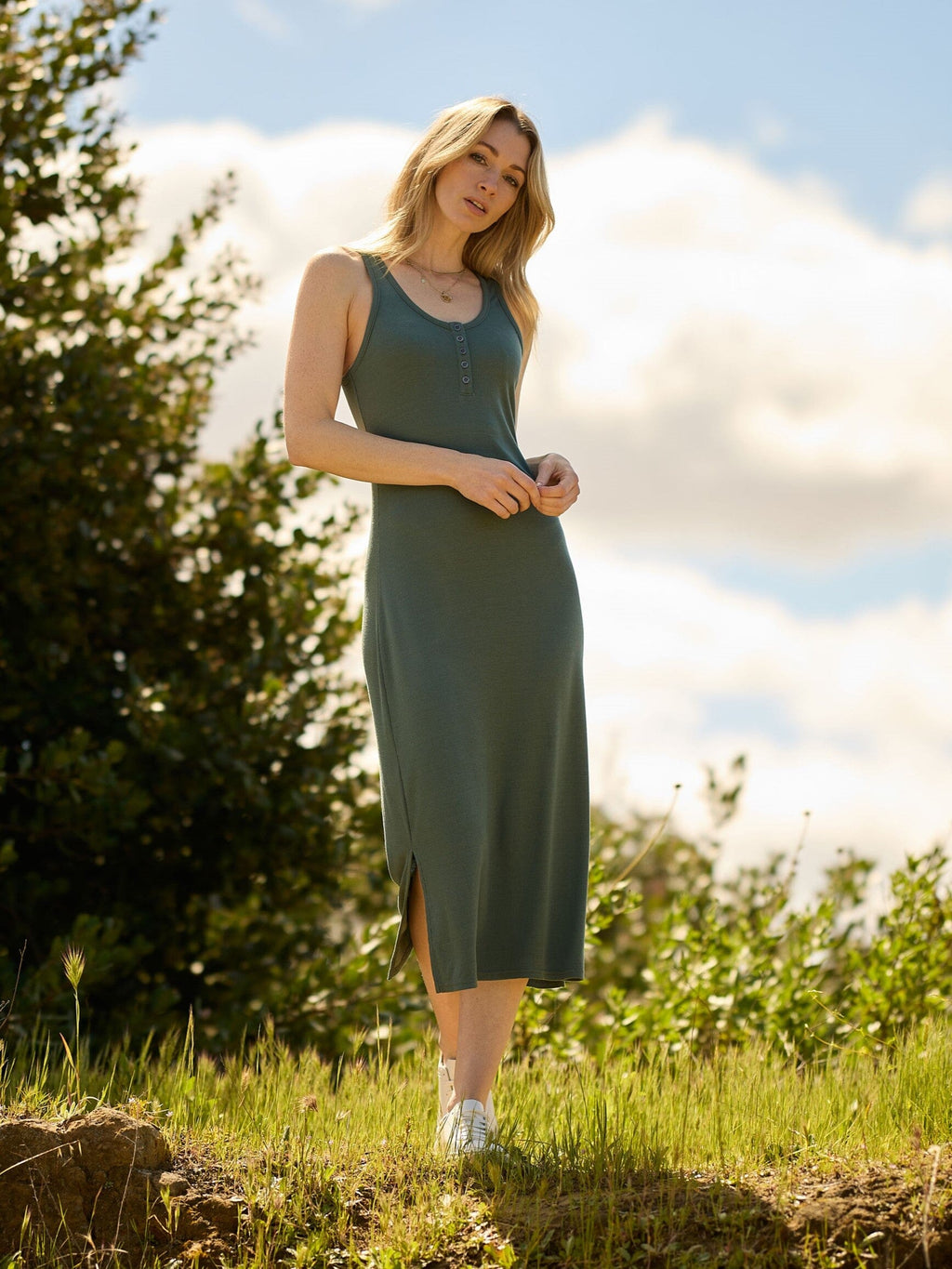 Model wearing a stretchy, sleeveless Feather Rib Henley Tank Dress with a casual aesthetic.