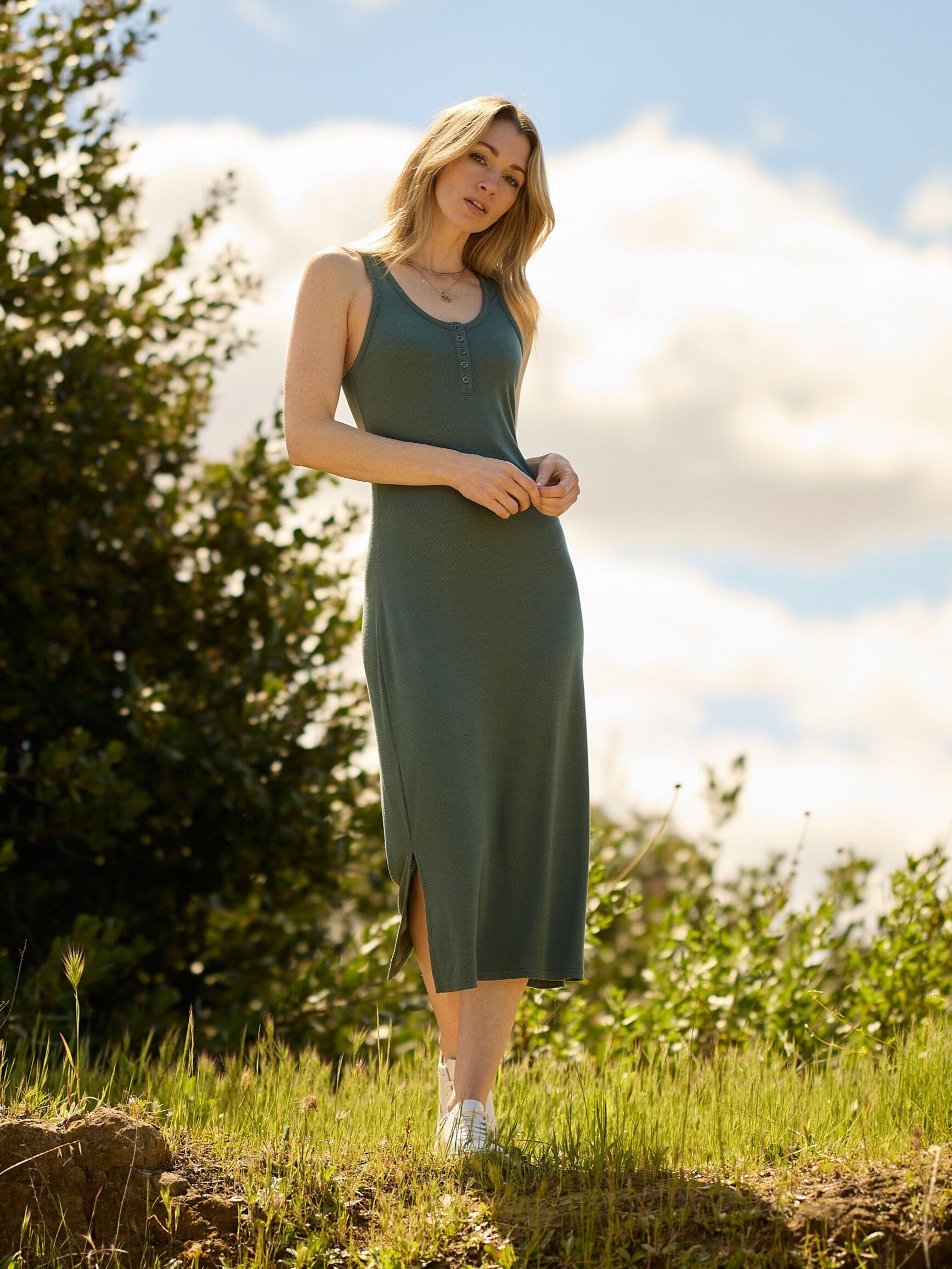 Model wearing a stretchy, sleeveless Feather Rib Henley Tank Dress with a casual aesthetic.