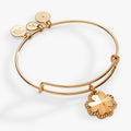 Silver-tone expandable wire bangle featuring a dimensional four-leaf clover charm.