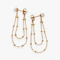 Close up of Freshwater Pearl Front-and-Back Earrings in polished gold with delicate cable chains.