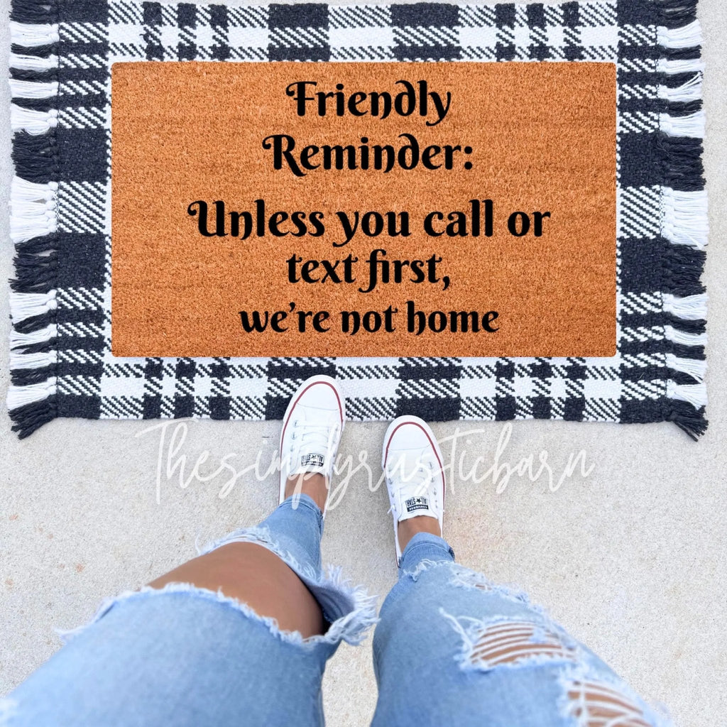 Natural coir farmhouse doormat with black text reading Unless You Call or Text First, placed on a porch.
