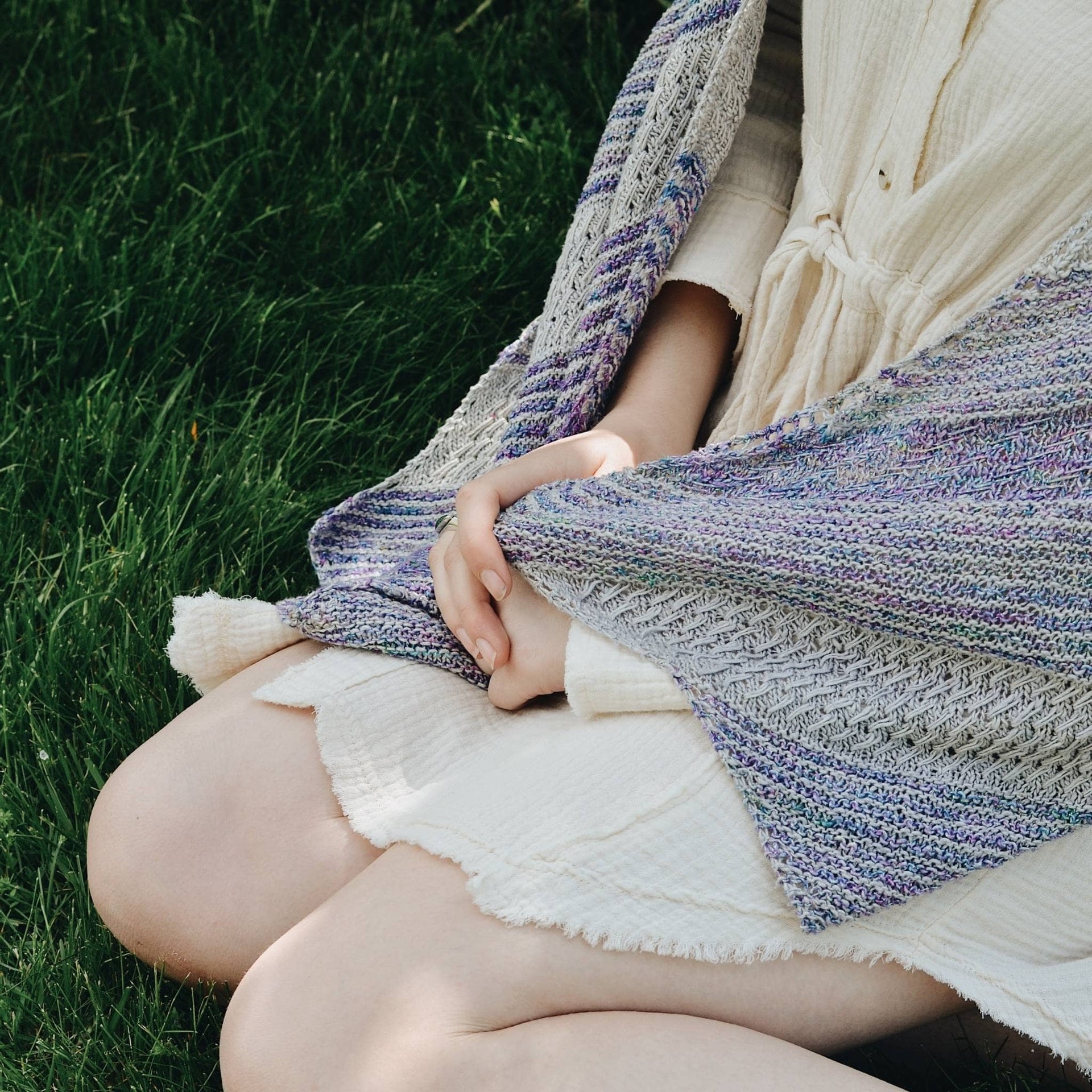 Elegant Frosted Forest Wrap knitting pattern displayed in shades of grey, purple, and blue.