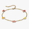 Gold-plated anklet featuring colorful enamel fruit charms including citrus and watermelon.
