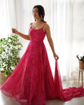 Woman wearing a pink chiffon kurta set with intricate sequin embroidery work