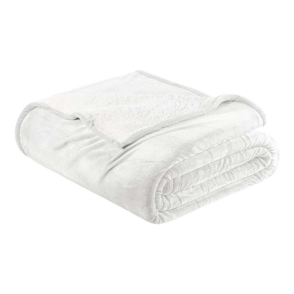 A white reversible velvet plush and sherpa fleece blanket folded neatly