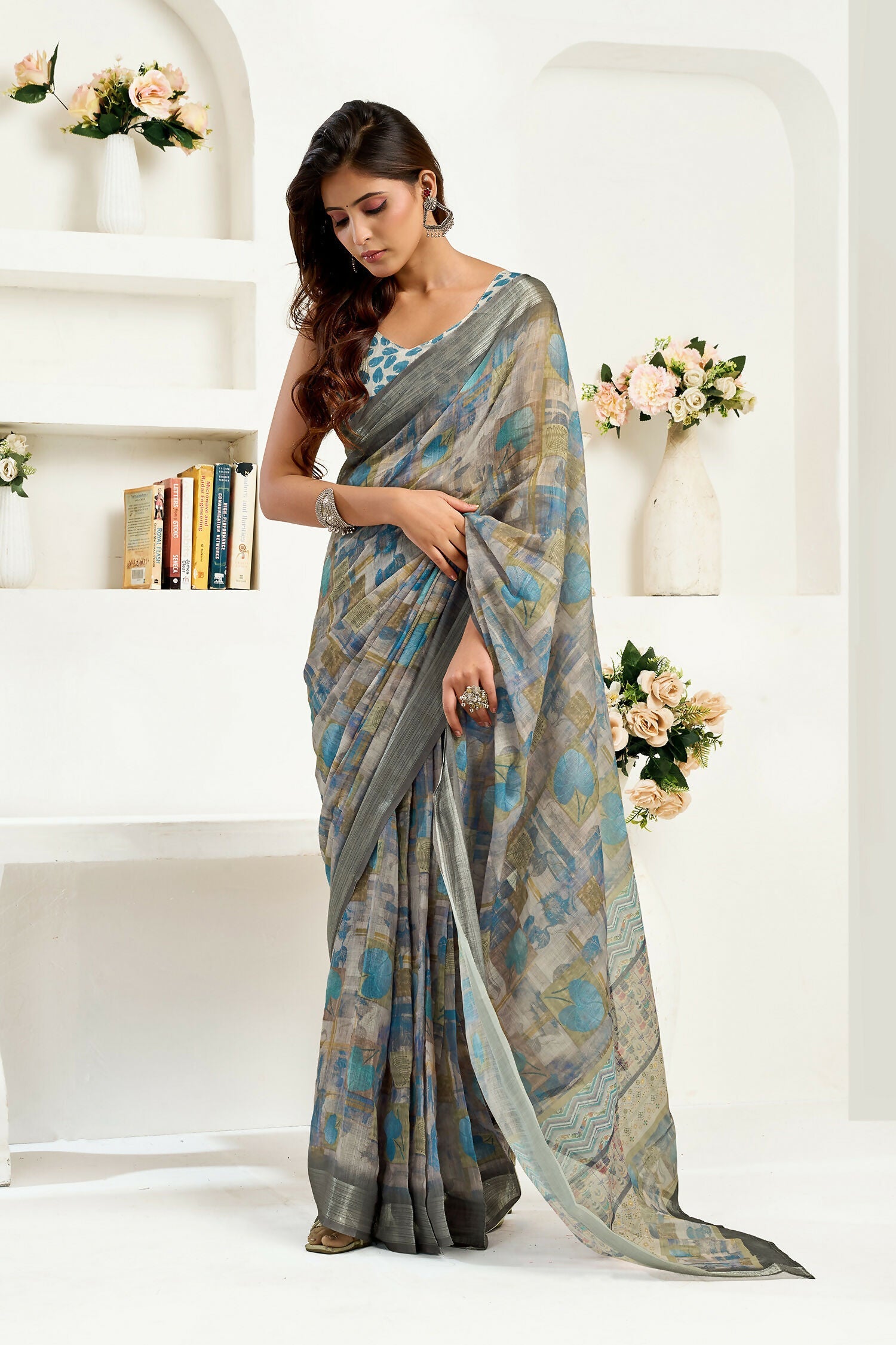 Dusty brown linen saree featuring floral and ethnic motifs with a matching unstitched blouse.