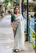 Green pure georgette saree with Warli print and aari mirror work border