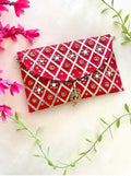 Red synthetic rectangular clutch bag with a magnetic lock closure
