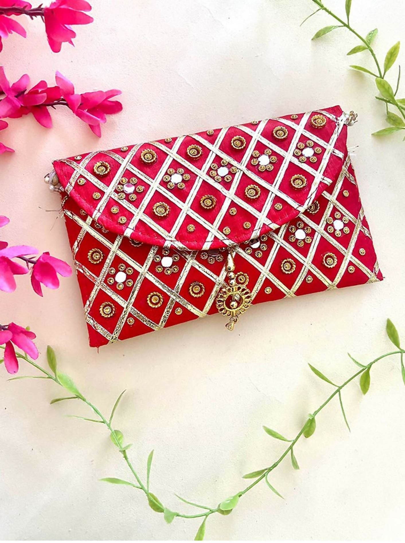 Red synthetic rectangular clutch bag with a magnetic lock closure