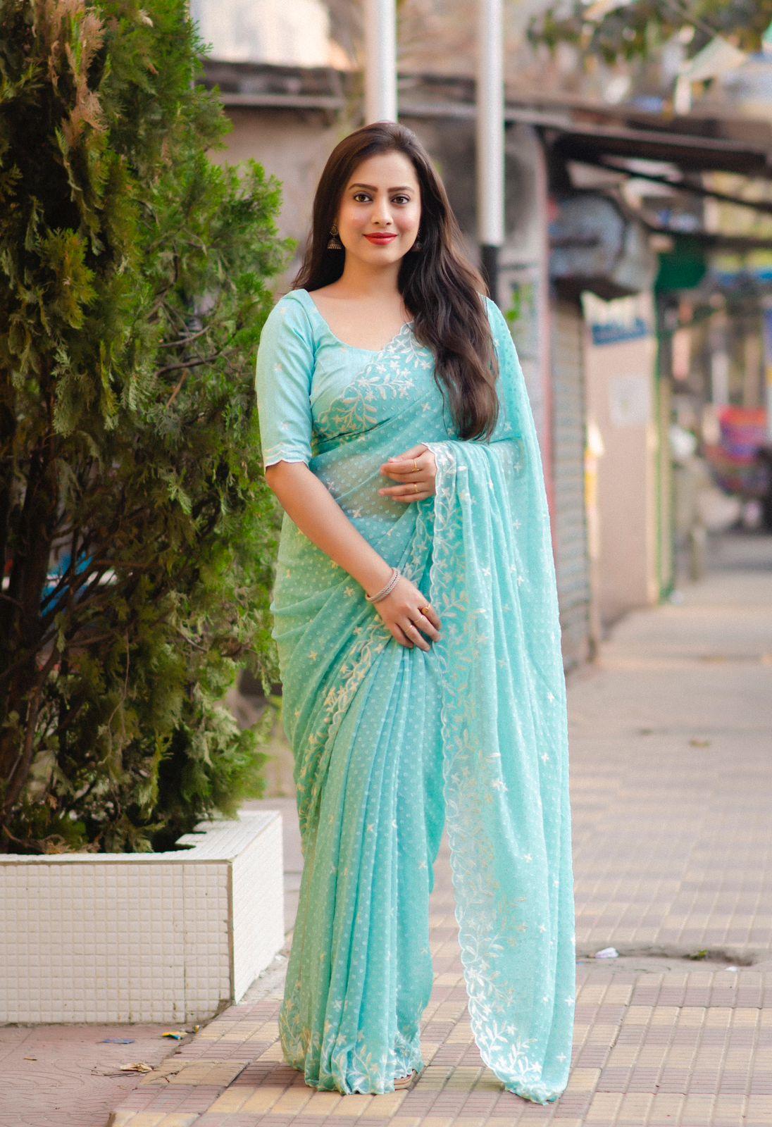 Sea green chiffon saree with woven butti, white thread embroidery, and matching phantom silk blouse.