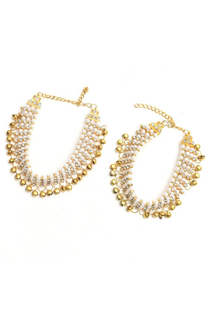 Elegant gold-polished anklets with white pearls displayed on a neutral background