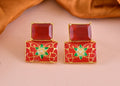A pair of luxurious red onyx drop earrings crafted in polished brass.
