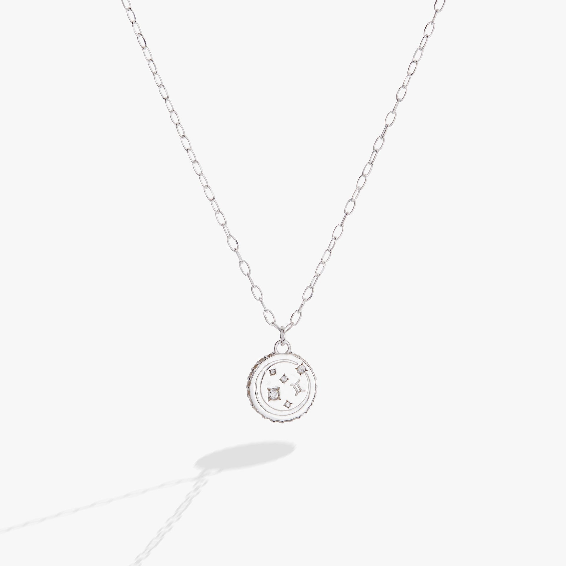 Silver Gemini zodiac pendant necklace with double-sided engraving and crystal accents.