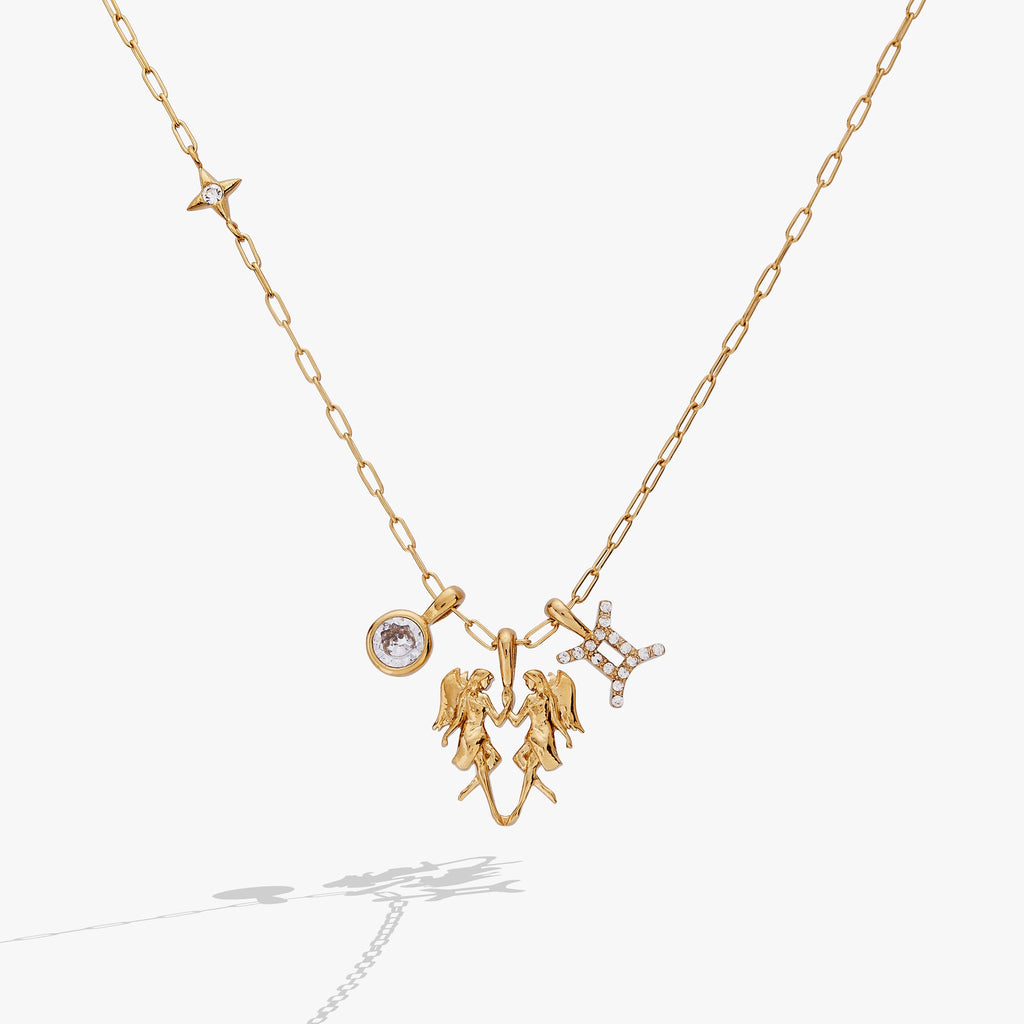 Gold-plated Gemini zodiac charm cluster necklace with crystal-pave twin motif.