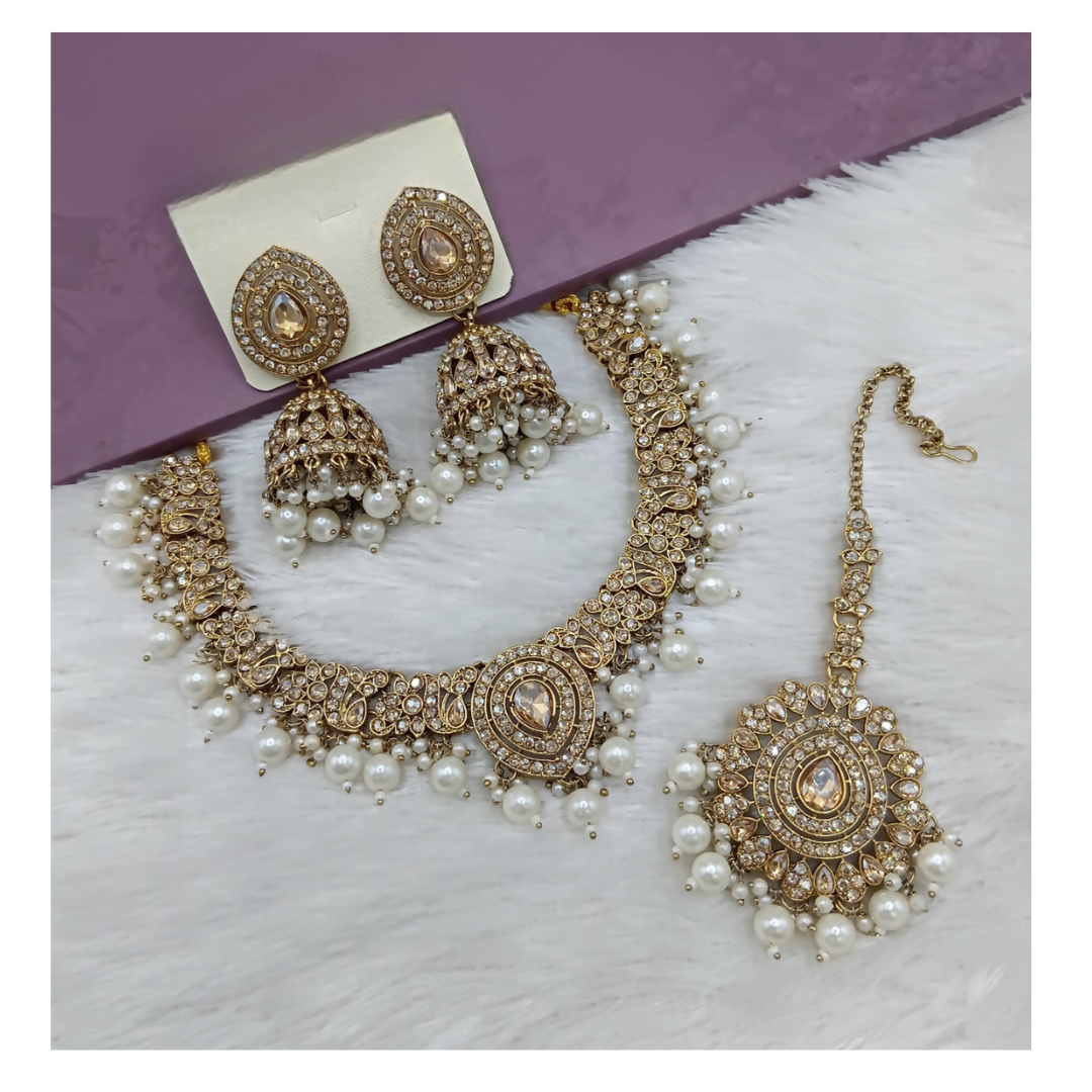 Elegant cream stone work necklace set with matching drop earrings on a neutral background