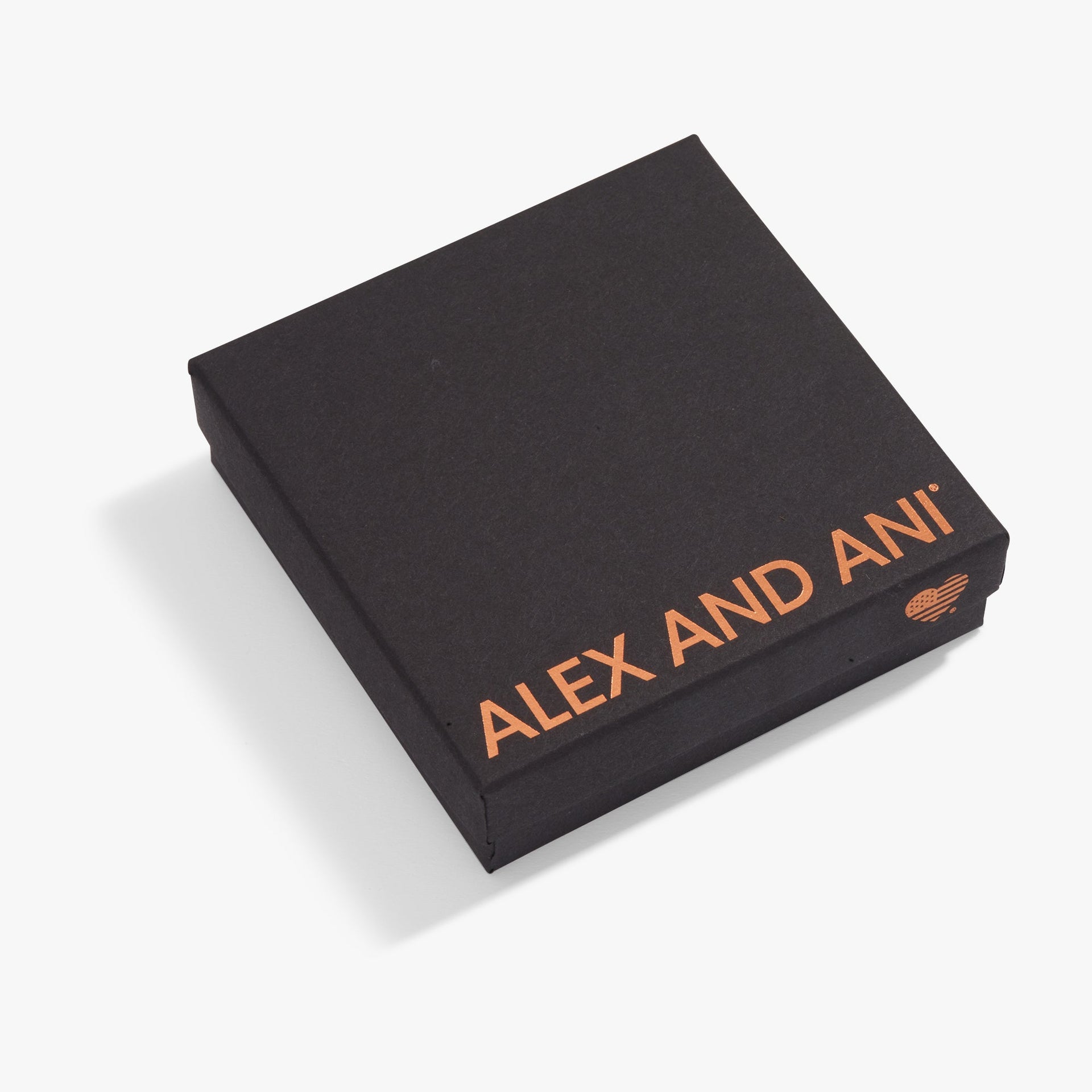 A minimalist square gift box in matte black with rose gold branding and a vibrant pink satin ribbon.