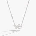 Silver-tone inline necklace featuring a glass butterfly pendant with snowflake etchings and clear crystal stones