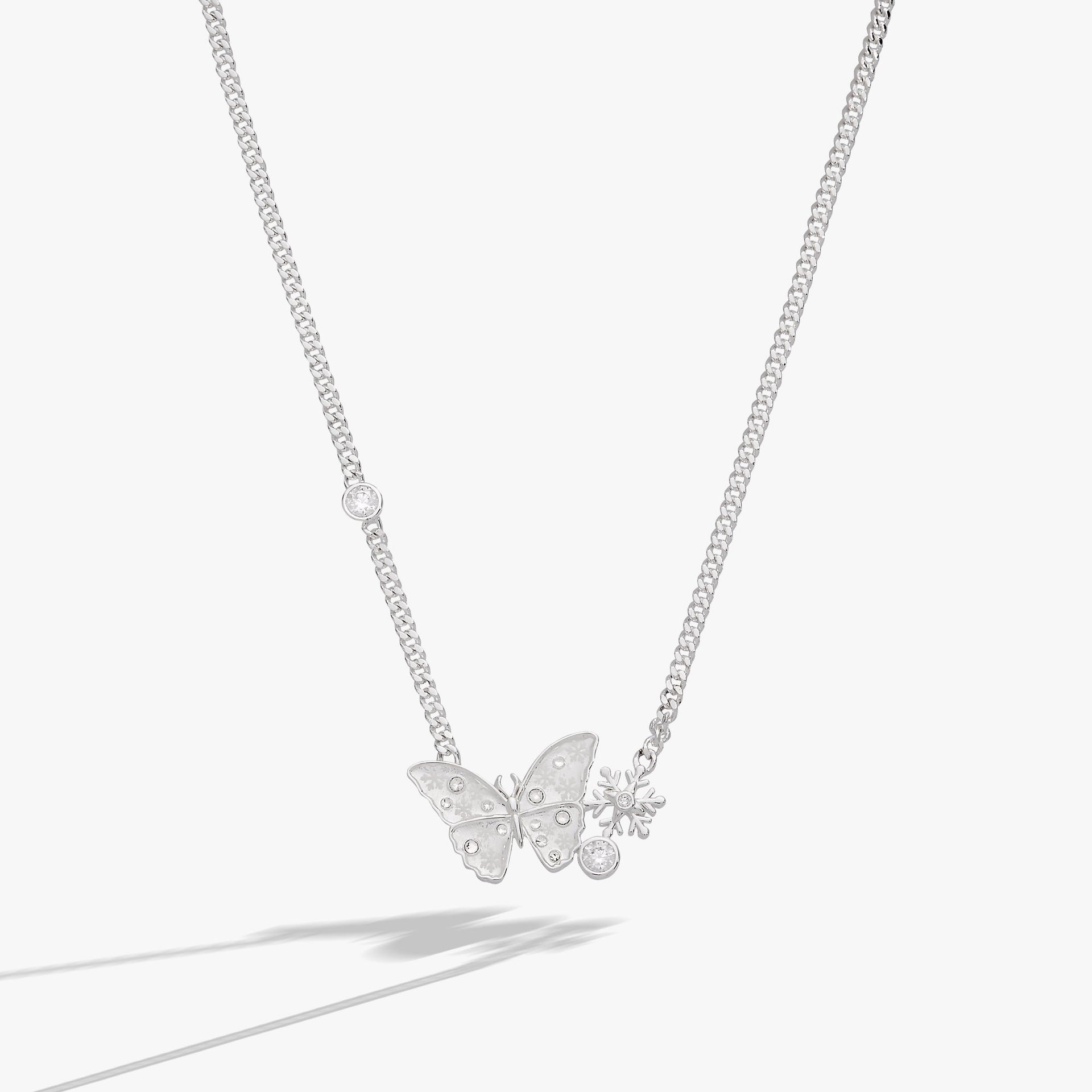 Silver-tone inline necklace featuring a glass butterfly pendant with snowflake etchings and clear crystal stones