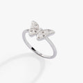 Silver butterfly statement ring featuring white enamel, snowflake etchings, and sparkling stones.