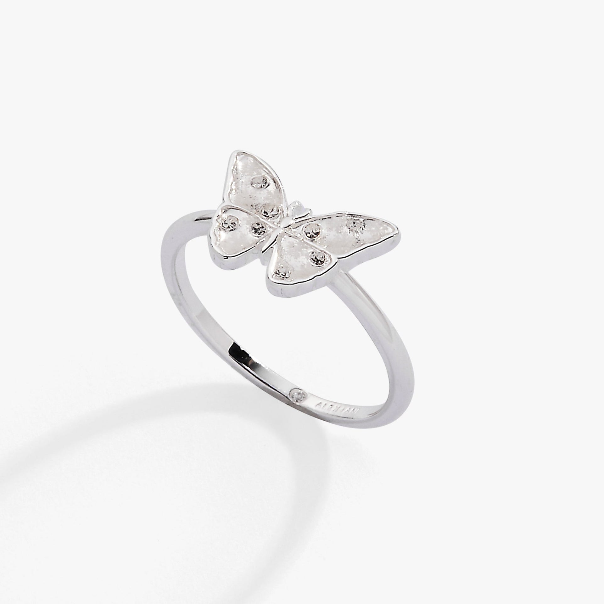 Silver butterfly statement ring featuring white enamel, snowflake etchings, and sparkling stones.