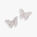 Close-up of glass butterfly statement stud earrings with snowflake patterns and shimmering stone accents