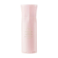 Oribe Serene Scalp Thickening Treatment Spray bottle in a soft pink minimalist setting