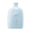Light blue bottle of Oribe Run-Through Detangling Shampoo 8.5 oz